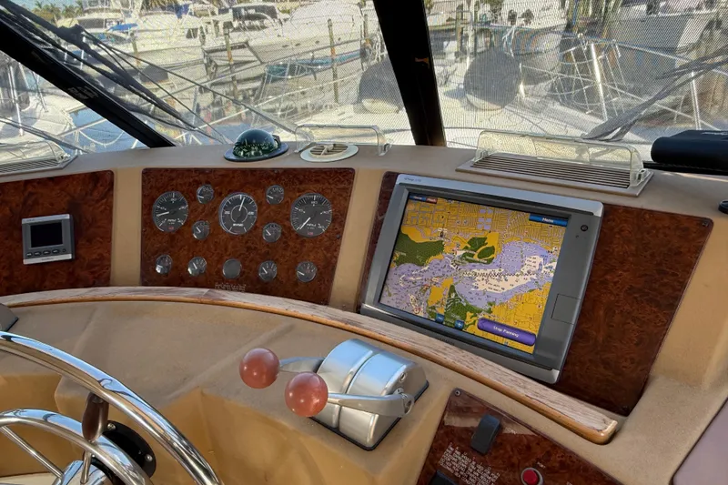 Slide: The Image of 2002 Bayliner 4788 Pilot House Motoryacht helm with navigation system and gauges. - 16