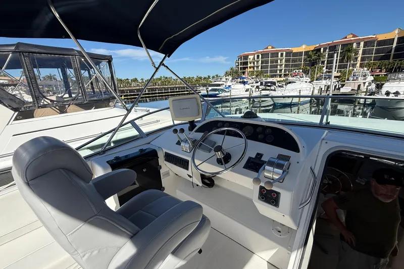Slide: The Image of 2002 Bayliner 4788 Pilot House Motoryacht helm with steering wheel and navigation equipment. - 18