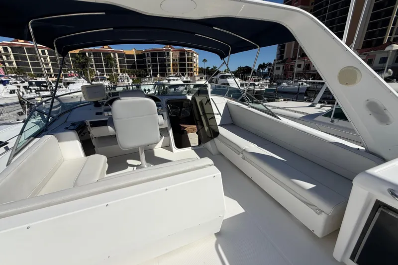 Slide: The Image of 2002 Bayliner 4788 Pilot House Motoryacht interior with seating and helm, docked at marina. - 19
