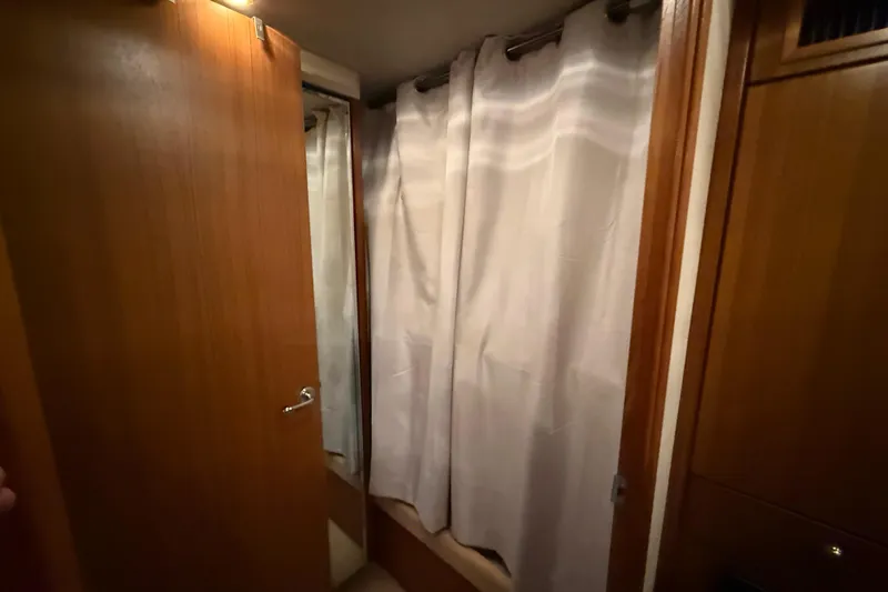 Slide: The Image of Interior of 2002 Bayliner 4788 Pilot House Motoryacht with wooden door and curtain. - 22