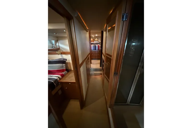 Slide: The Image of Interior hallway of 2002 Bayliner 4788 Pilot House Motoryacht, featuring cozy cabins. - 25