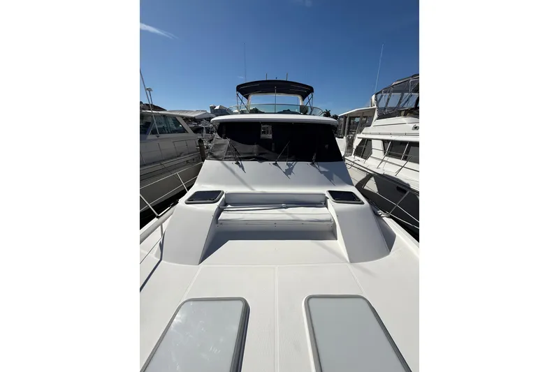 Slide: The Image of 2002 Bayliner 4788 Pilot House Motoryacht docked under clear blue sky. - 27