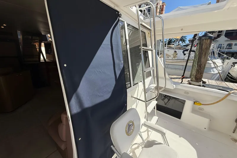 Slide: The Image of 2002 Bayliner 4788 Pilot House Motoryacht deck with ladder and seating area. - 4