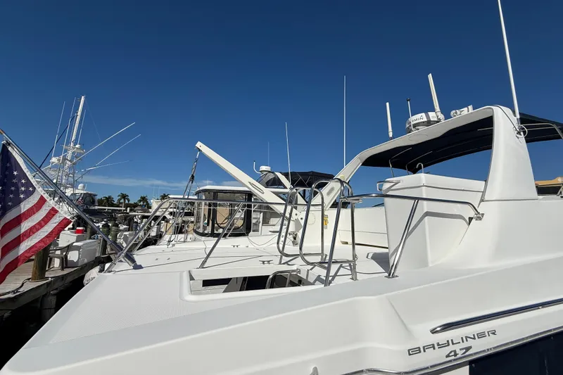 Slide: The Image of 2002 Bayliner 4788 Pilot House Motoryacht docked under clear blue sky. - 5