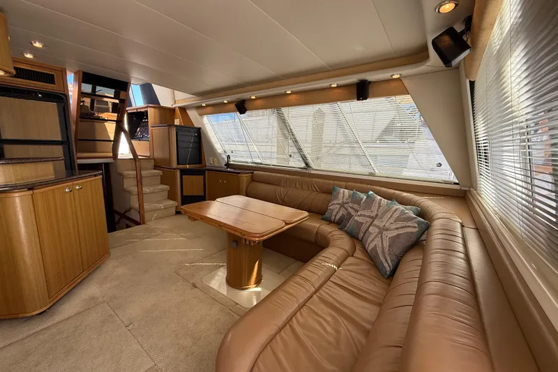 Slide: The Image of Luxurious interior of 2002 Bayliner 4788 Pilot House Motoryacht with plush seating and elegant decor. - 7