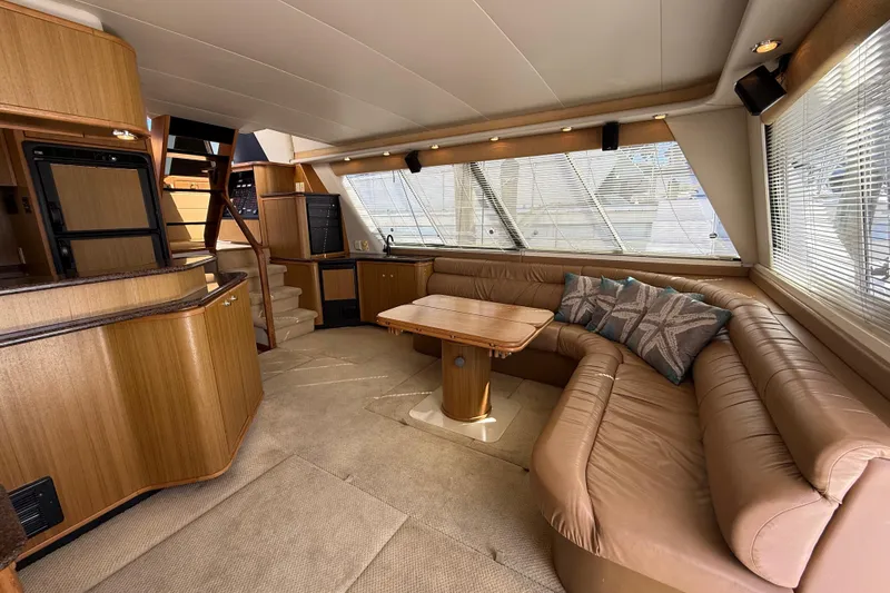 Slide: The Image of Luxurious interior of 2002 Bayliner 4788 Pilot House Motoryacht with plush seating and elegant wood finishes. - 8