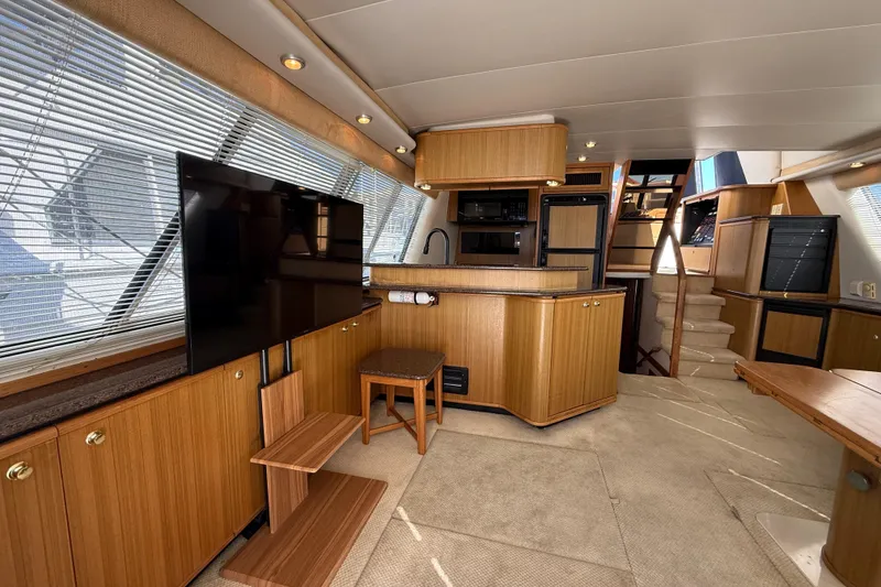 Slide: The Image of Interior of 2002 Bayliner 4788 Pilot House Motoryacht with modern kitchen and entertainment area. - 9