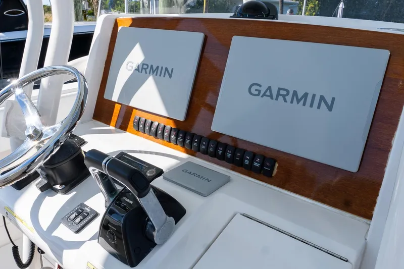 Slide: The Image of Control panel of 2013 Jupiter 34 FS boat with Garmin navigation displays. - 10