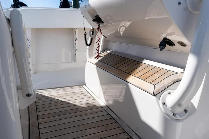 Slide: The Image of 2013 Jupiter 34 FS boat interior with wooden deck and seating area. - 17