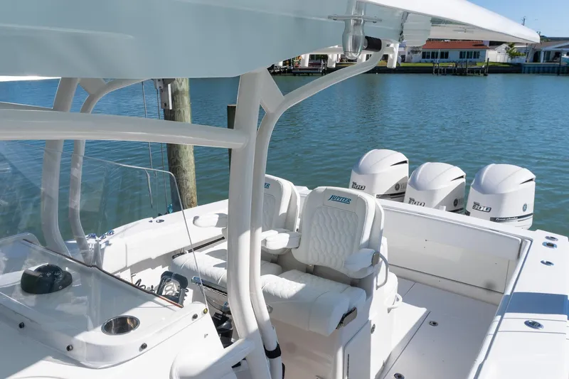 Slide: The Image of 2013 Jupiter 34 FS boat with quad engines docked by the water. - 27