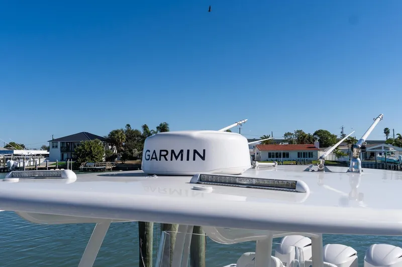 Slide: The Image of 2013 Jupiter 34 FS boat with Garmin radar, docked near waterfront homes. - 28