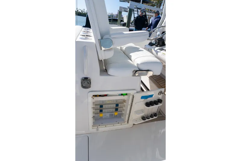 Slide: The Image of 2013 Jupiter 34 FS boat interior with white seating and storage compartments. - 31