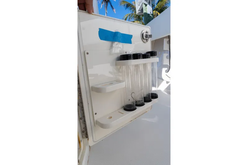 Slide: The Image of 2013 Jupiter 34 FS boat storage compartment with test tubes and blue tape. - 32