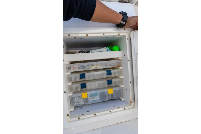 Slide: The Image of Storage compartment with organized tackle boxes on a 2013 Jupiter 34 FS boat. - 33