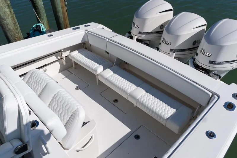 Slide: The Image of 2013 Jupiter 34 FS boat interior with white seating and triple outboard engines. - 35