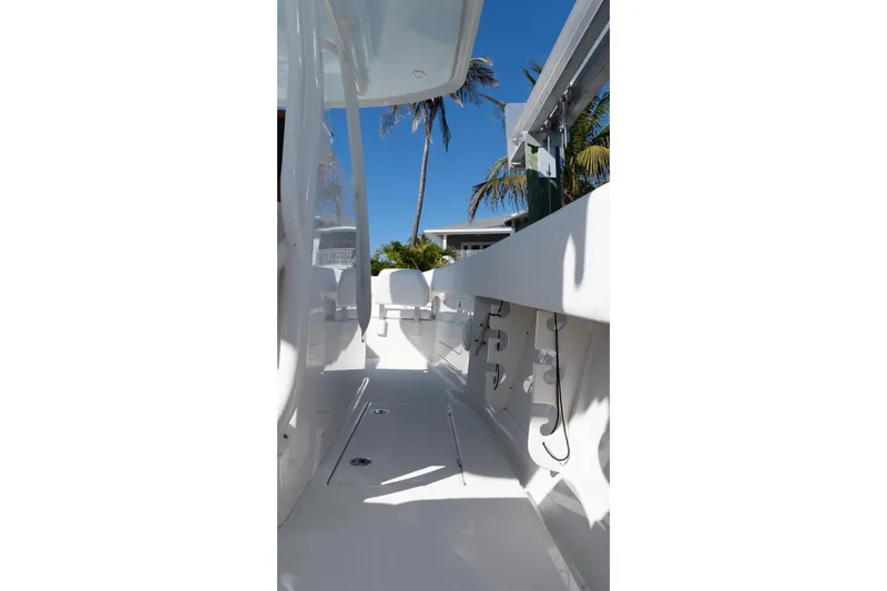 Slide: The Image of 2013 Jupiter 34 FS boat interior with sleek white design and palm trees in background. - 38