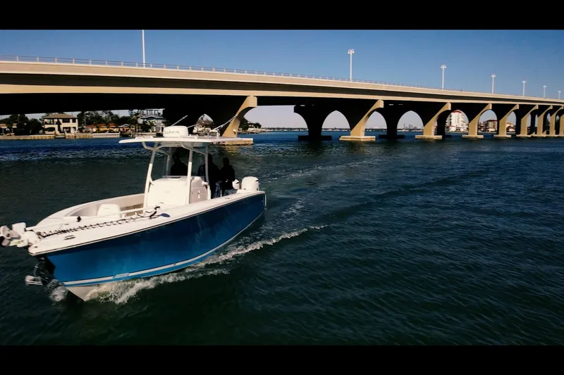 Slide: The Image of 2013 Jupiter 34 FS boat cruising under a bridge on a sunny day. - 4