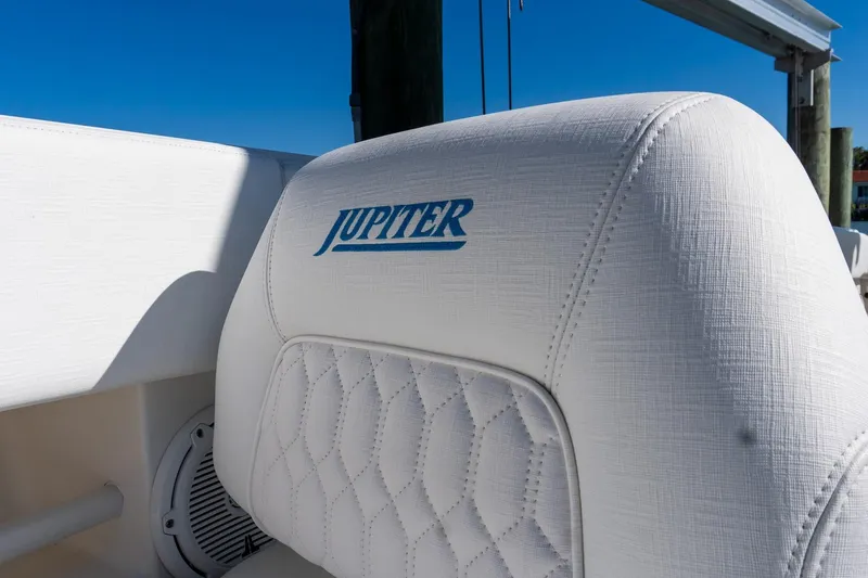 Slide: The Image of 2013 Jupiter 34 FS boat seat with logo, featuring white quilted upholstery. - 43