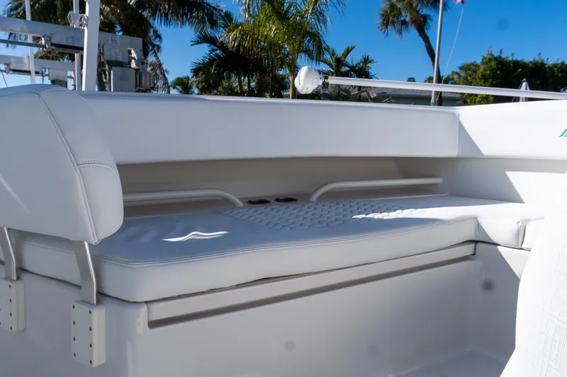 Slide: The Image of White seating area on a 2013 Jupiter 34 FS boat, with palm trees in the background. - 44