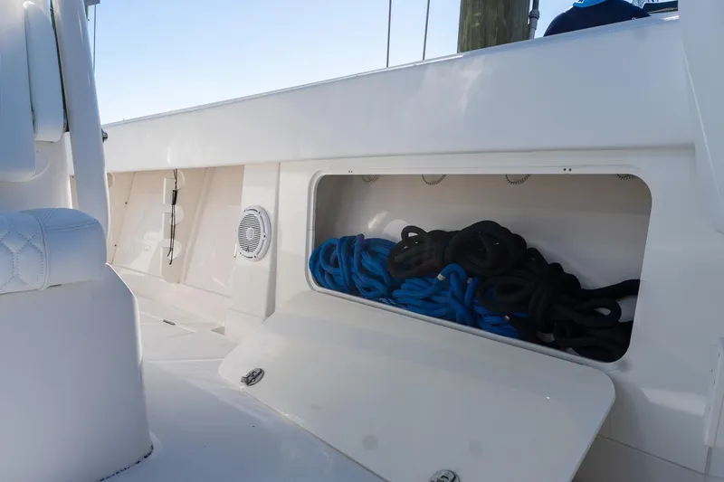 Slide: The Image of 2013 Jupiter 34 FS boat storage compartment with blue and black ropes. - 45
