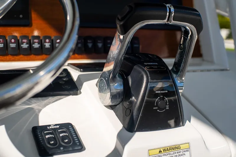 Slide: The Image of Close-up of 2013 Jupiter 34 FS boat controls with Yamaha throttle and steering wheel. - 49