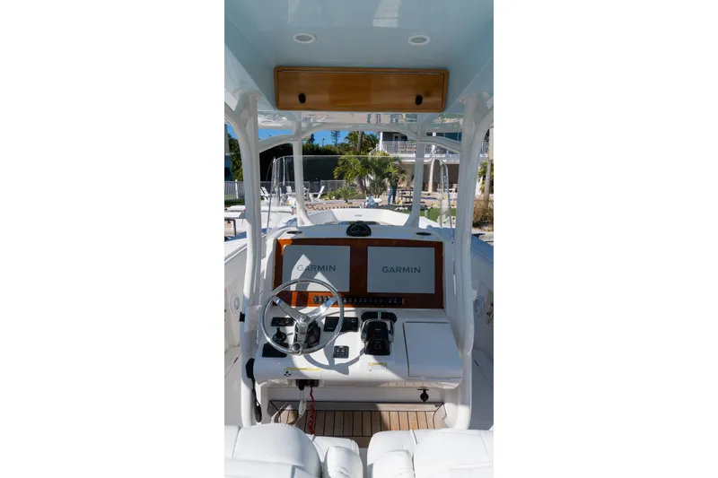 Slide: The Image of 2013 Jupiter 34 FS boat helm with Garmin navigation system and steering wheel. - 8