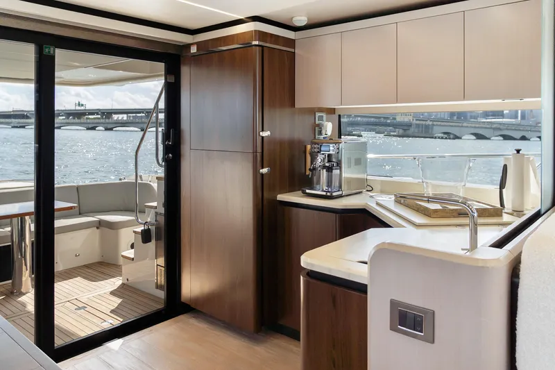 Slide: The Image of Luxurious interior of 2019 Absolute 58 FLY yacht with modern kitchen and scenic water view. - 11