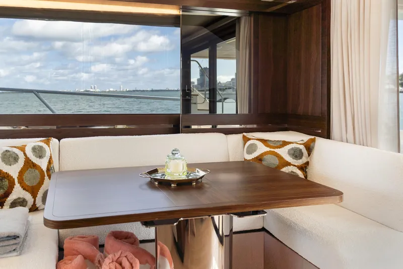 Slide: The Image of Luxurious interior of 2019 Absolute 58 FLY yacht with elegant dining area and scenic ocean view. - 14