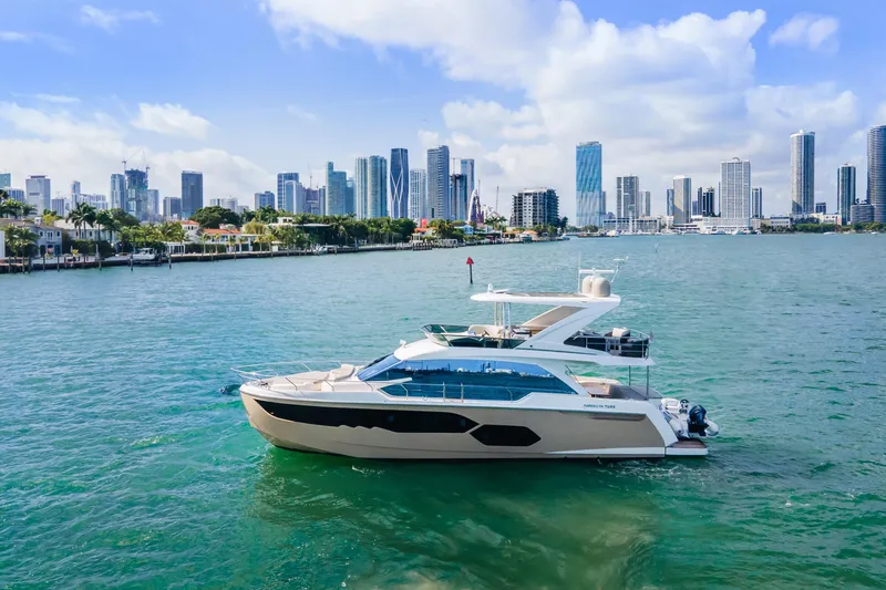 Slide: The Image of Luxurious 2019 Absolute 58 FLY yacht cruising on open water. - 2