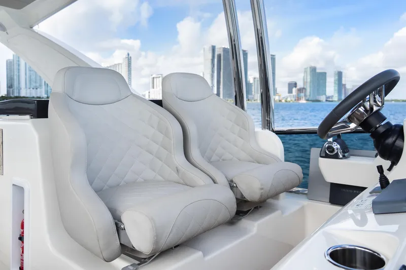 Slide: The Image of Luxurious seating on 2019 Absolute 58 FLY yacht with city skyline in background. - 37