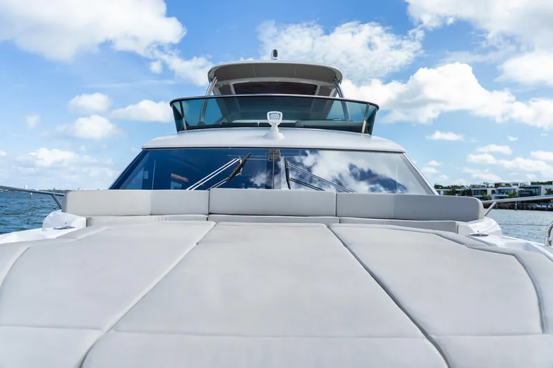 Slide: The Image of Luxurious 2019 Absolute 58 FLY yacht cruising near a city skyline on a sunny day. - 38