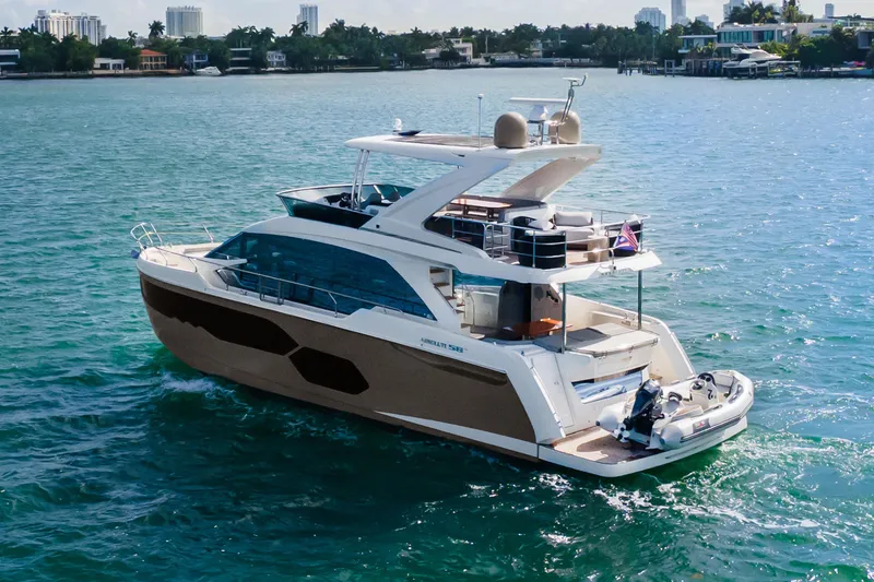 Slide: The Image of Luxury 2019 Absolute 58 FLY yacht cruising on clear blue waters. - 4