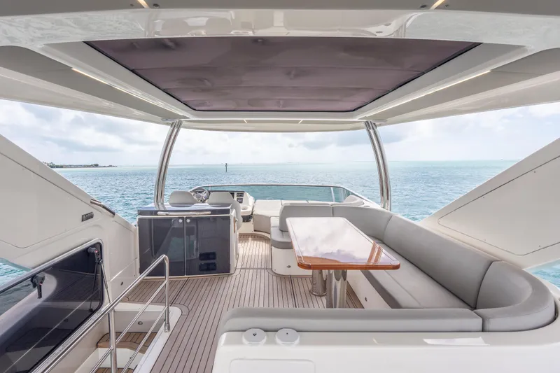 Slide: The Image of Luxurious 2019 Absolute 58 FLY yacht interior with ocean view, featuring elegant seating and table. - 47