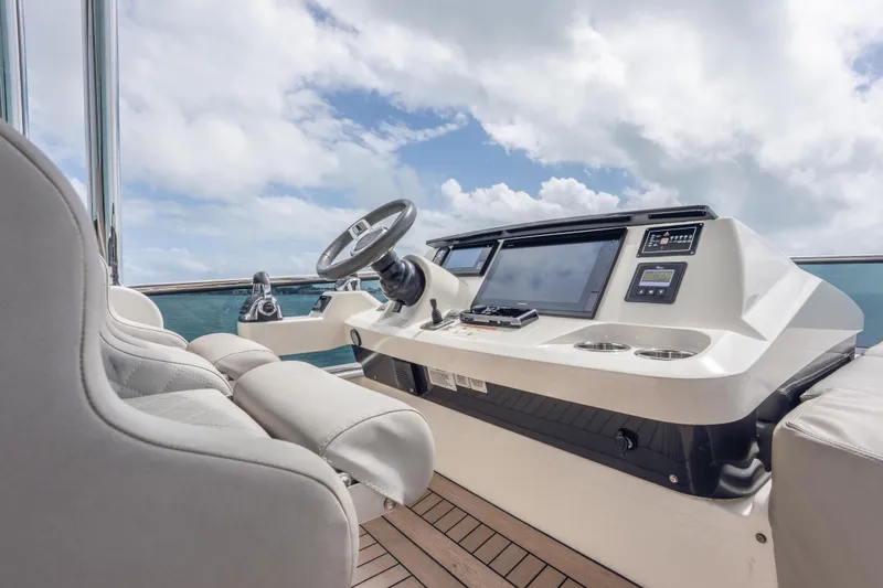 Slide: The Image of Luxurious helm of 2019 Absolute 58 FLY yacht with modern controls and ocean view. - 49