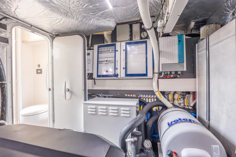 Slide: The Image of Engine room of 2019 Absolute 58 FLY yacht with technical equipment and wiring. - 58