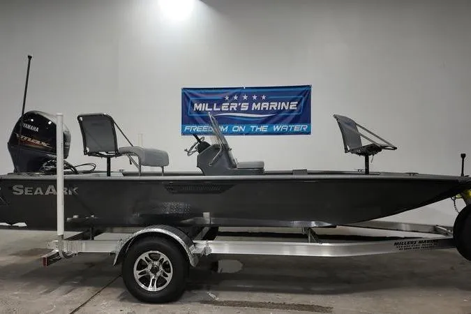 Slide: The Image of 2025 SeaArk Shadow 18T boat on trailer at Miller's Marine showroom. - 0