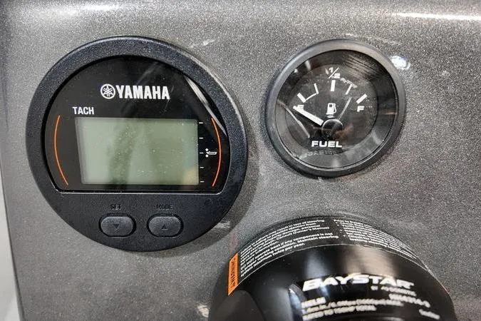 Slide: The Image of Yamaha tachometer and fuel gauge on 2025 SeaArk Shadow 18T dashboard. - 10