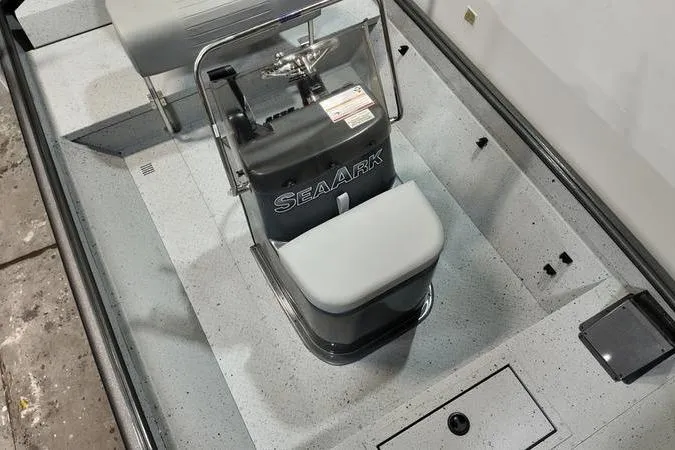 Slide: The Image of 2025 SeaArk Shadow 18T boat interior with steering console and seating. - 12