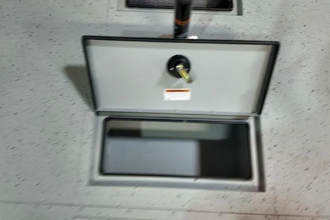 Slide: The Image of Open storage compartment on 2025 SeaArk Shadow 18T boat deck. - 16