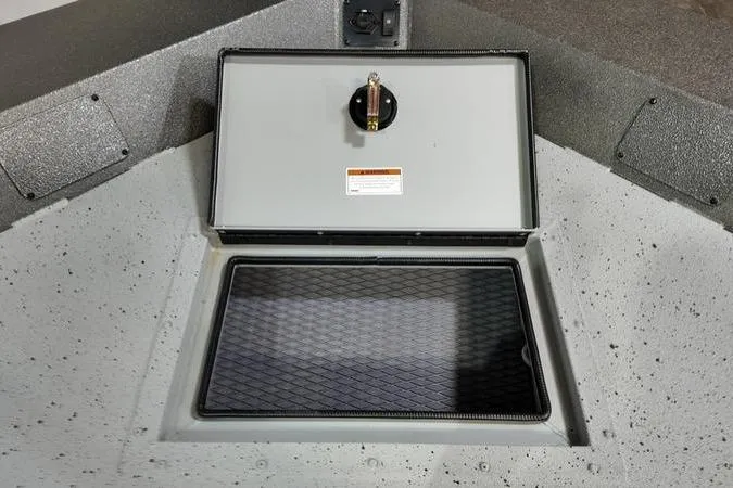 Slide: The Image of 2025 SeaArk Shadow 18T boat storage compartment with secure latch and textured interior. - 17
