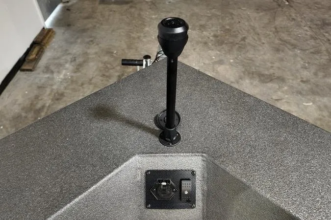 Slide: The Image of 2025 SeaArk Shadow 18T boat interior with control panel and handle. - 18