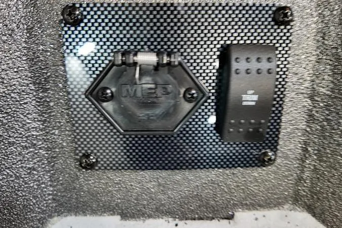 Slide: The Image of Close-up of a 2025 SeaArk Shadow 18T boat's control panel with textured surface. - 19