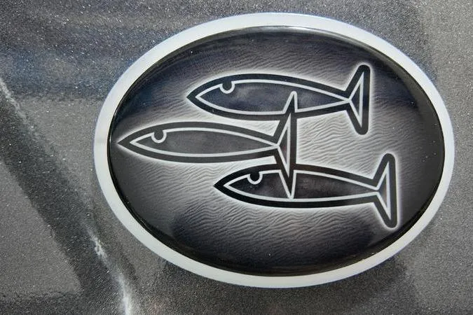 Slide: The Image of Logo of three fish on a 2025 SeaArk Shadow 18T boat. - 21