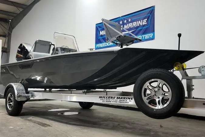 Slide: The Image of 2025 SeaArk Shadow 18T boat on trailer at Miller's Marine showroom. - 3