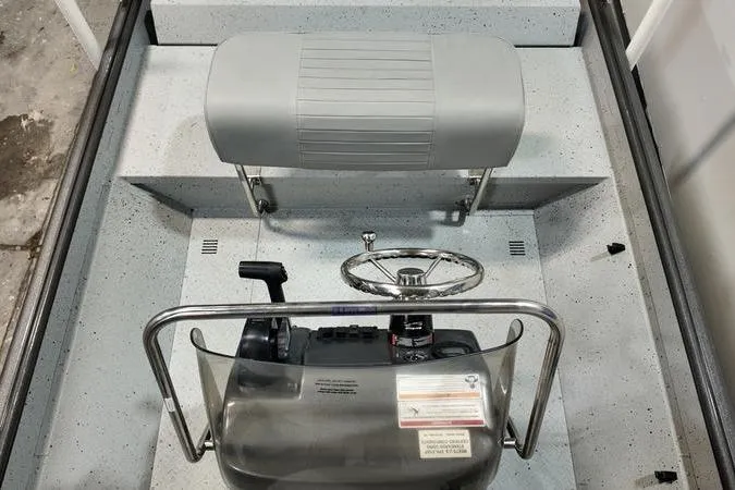 Slide: The Image of 2025 SeaArk Shadow 18T boat interior with steering console and seating. - 8