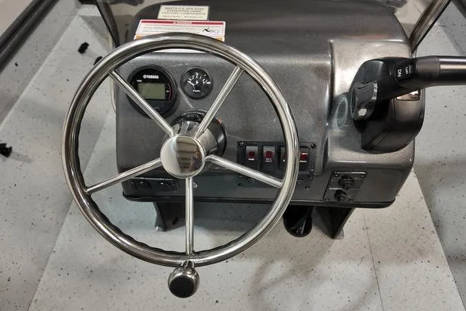 Slide: The Image of Steering console of 2025 SeaArk Shadow 18T boat with controls and gauges. - 9