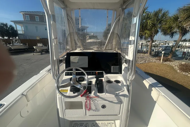 Slide: The Image of 2019 Sea Hunt Ultra 211 boat console with steering wheel and Garmin display. - 10