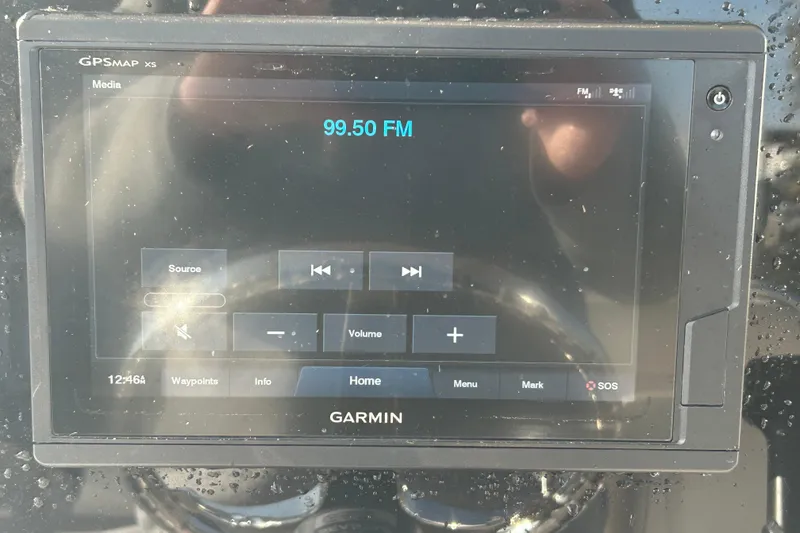 Slide: The Image of Garmin GPS display on 2019 Sea Hunt Ultra 211, tuned to 99.50 FM. - 16