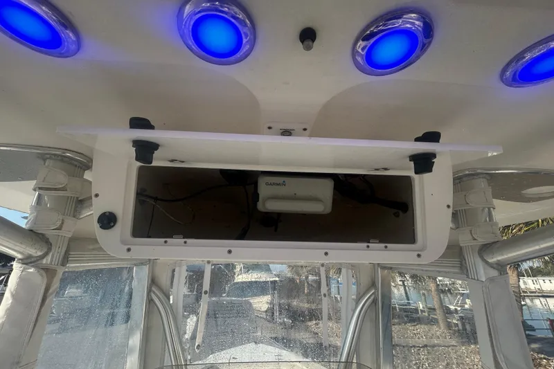 Slide: The Image of 2019 Sea Hunt Ultra 211 boat console with blue LED lights and Garmin equipment. - 18