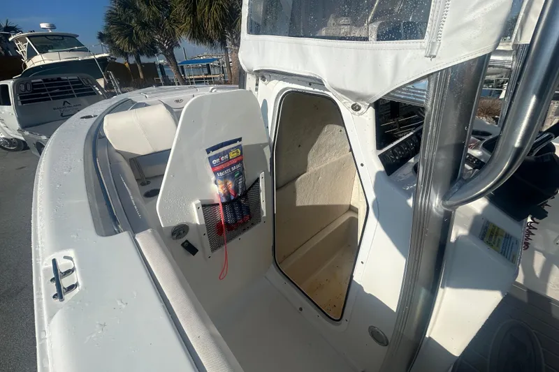 Slide: The Image of 2019 Sea Hunt Ultra 211 boat interior with storage compartment and seating. - 21